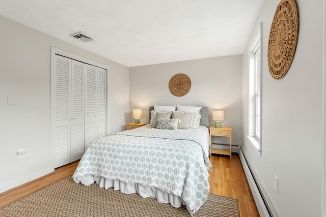 3 Penni Ln, Andover, MA 01810 - bedroom featuring a baseboard radiator, light wood-type flooring, a closet, and baseboard heating