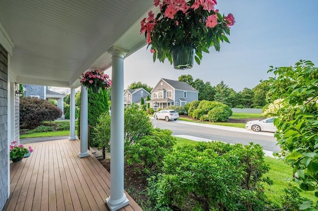 deck with covered porch and a residential view