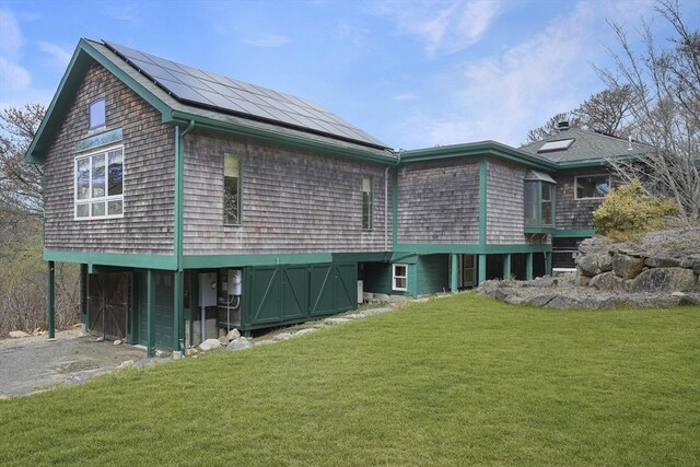 79 David Ave, Tisbury, MA 02568 - back of house featuring a lawn and roof mounted solar panels