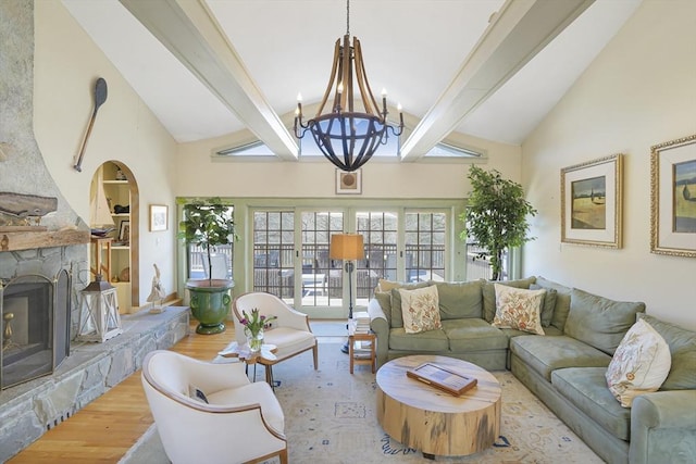 79 David Ave, Tisbury, MA 02568 - living area with beam ceiling, high vaulted ceiling, wood finished floors, a chandelier, and healthy amount of natural light