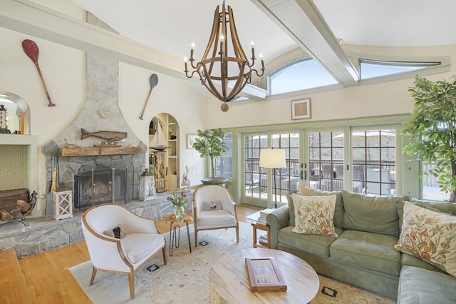 79 David Ave, Tisbury, MA 02568 - living room with wood finished floors, a stone fireplace, a chandelier, beamed ceiling, and high vaulted ceiling