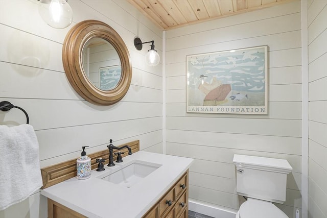79 David Ave, Tisbury, MA 02568 - bathroom featuring vanity, wooden ceiling, toilet, and wood walls