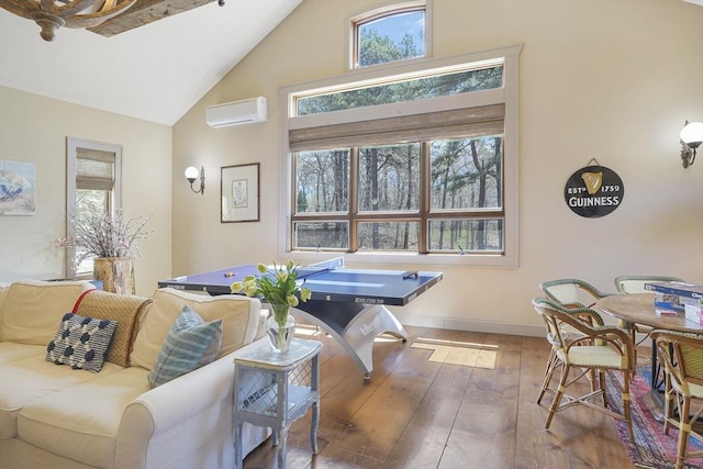 79 David Ave, Tisbury, MA 02568 - living room featuring an AC wall unit, hardwood / wood-style floors, healthy amount of natural light, high vaulted ceiling, and baseboards