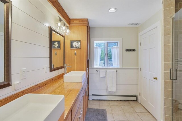 79 David Ave, Tisbury, MA 02568 - full bathroom with a baseboard radiator, double vanity, a tile shower, tile patterned floors, and recessed lighting