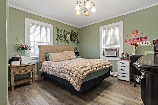 bedroom with cooling unit, an inviting chandelier, hardwood / wood-style flooring, and crown molding