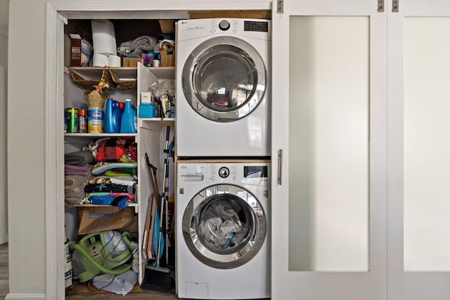 clothes washing area with stacked washer and clothes dryer