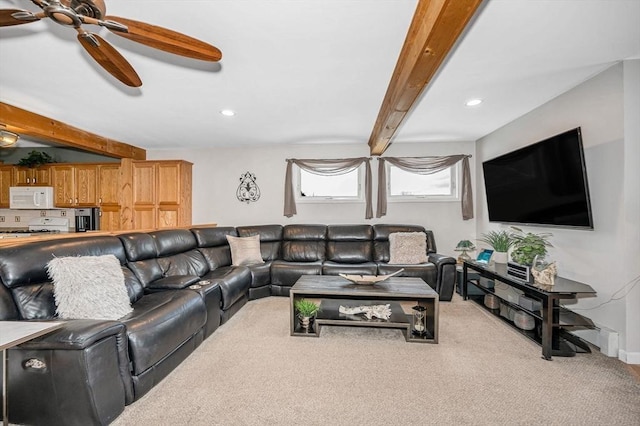 living room featuring ceiling fan, beam ceiling, and carpet