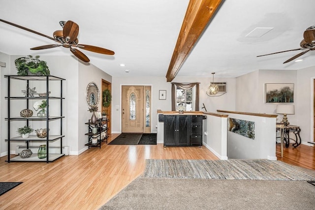 entryway featuring a baseboard radiator, wood-type flooring, and beam ceiling