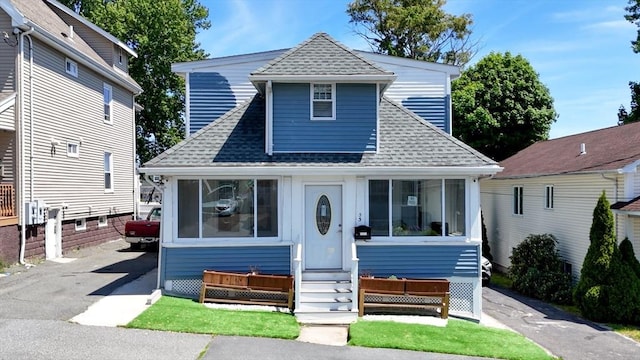 33 Jarvis St, Revere, MA 02151 - view of front facade with a shingled roof, entry steps, and driveway