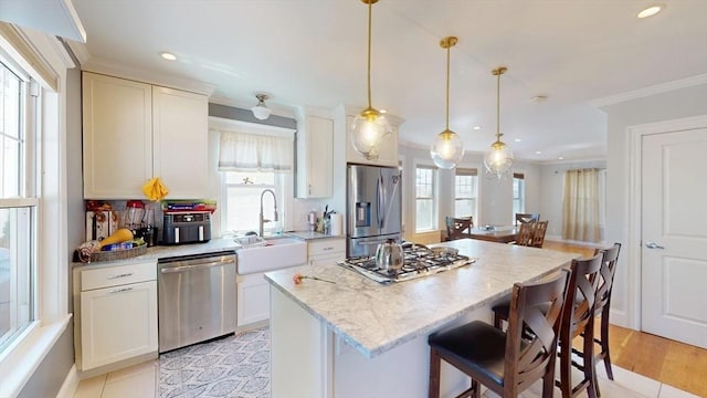 33 Jarvis St, Revere, MA 02151 - kitchen featuring stainless steel appliances, a sink, a center island, a breakfast bar area, and recessed lighting