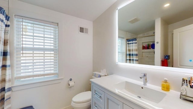 33 Jarvis St, Revere, MA 02151 - full bath with plenty of natural light, vanity, toilet, and a shower with shower curtain