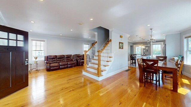 33 Jarvis St, Revere, MA 02151 - dining room with crown molding, light wood-type flooring, baseboards, recessed lighting, and stairs