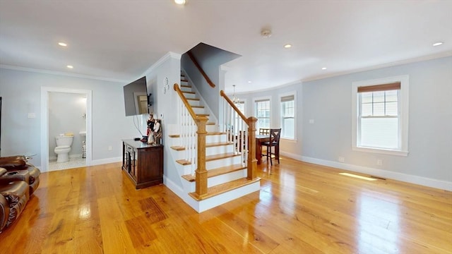 33 Jarvis St, Revere, MA 02151 - stairway with ornamental molding, recessed lighting, wood finished floors, and baseboards
