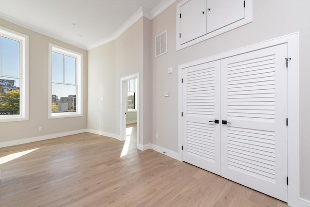 hall featuring crown molding and light hardwood / wood-style flooring