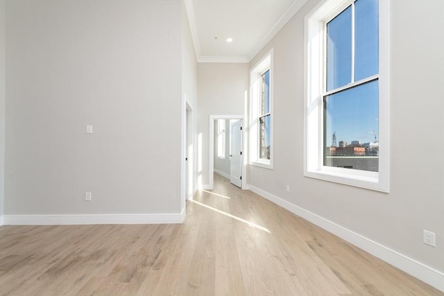 interior space featuring ornamental molding and light hardwood / wood-style flooring