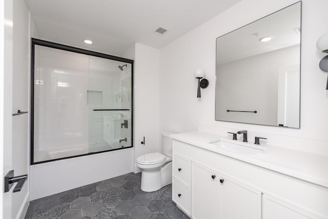 full bathroom with vanity, combined bath / shower with glass door, and toilet