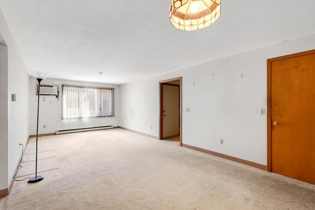 spare room with baseboards, a baseboard heating unit, and light colored carpet