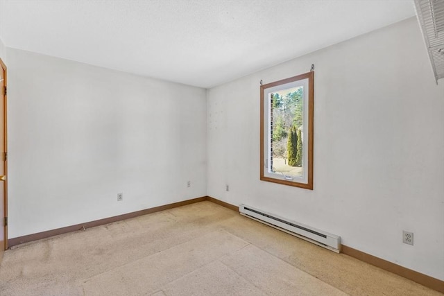 empty room with a baseboard heating unit, light colored carpet, a textured ceiling, and baseboards