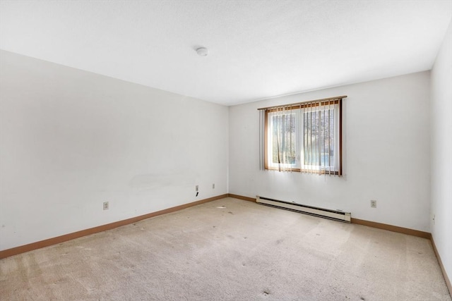 carpeted spare room featuring baseboards and baseboard heating