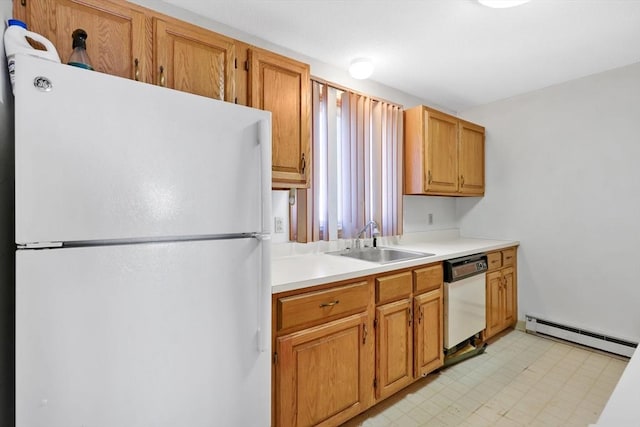 kitchen with white appliances, light countertops, light floors, a baseboard heating unit, and a sink