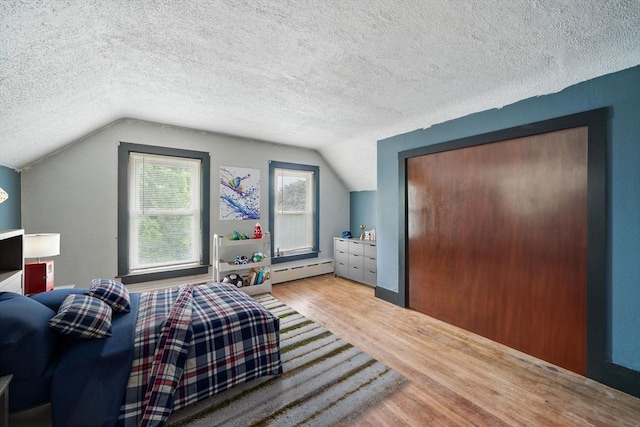 6 Hart Ave, Taunton, MA 02780 - bedroom featuring wood finished floors, vaulted ceiling, baseboard heating, and a textured ceiling