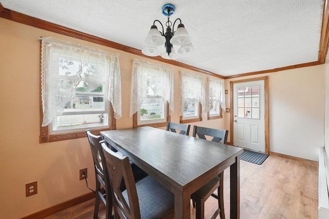6 Hart Ave, Taunton, MA 02780 - dining room featuring a chandelier, crown molding, baseboards, light wood-style floors, and a textured ceiling