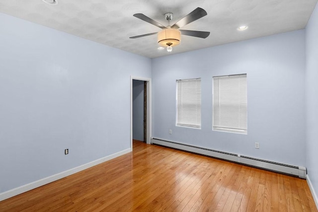 unfurnished room with a baseboard radiator, recessed lighting, ceiling fan, baseboards, and hardwood / wood-style flooring