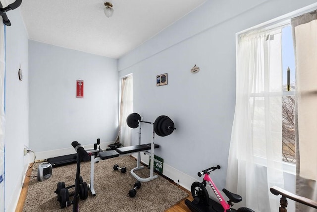 workout room with plenty of natural light and baseboards