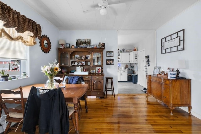 dining room with light wood-type flooring and a ceiling fan