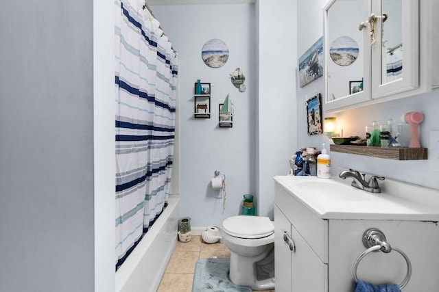 bathroom with shower / tub combo with curtain, toilet, vanity, baseboards, and tile patterned floors