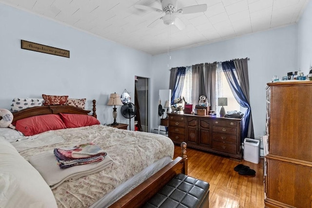 bedroom with hardwood / wood-style flooring and a ceiling fan