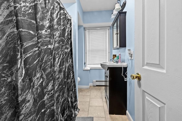 bathroom with baseboards, curtained shower, tile patterned flooring, baseboard heating, and vanity