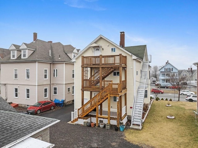 view of playground with a deck, cooling unit, a yard, stairway, and a residential view