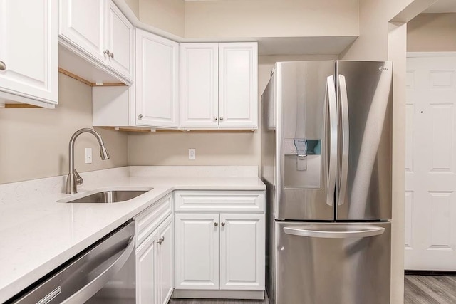 4975 Washington St Unit 313, Boston, MA 02132 - kitchen with stainless steel appliances, a sink, and white cabinetry