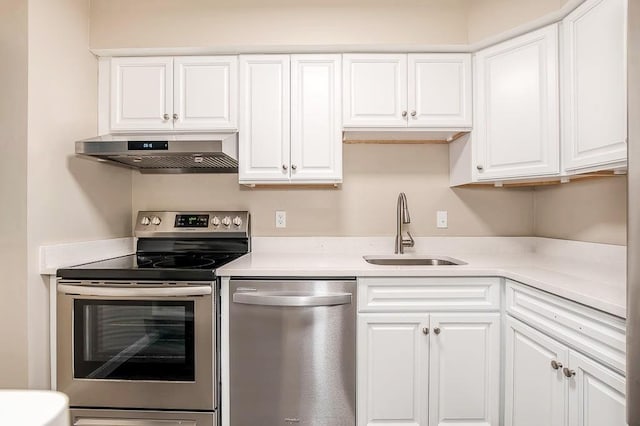 4975 Washington St Unit 313, Boston, MA 02132 - kitchen featuring stainless steel appliances, range hood, a sink, white cabinetry, and light countertops