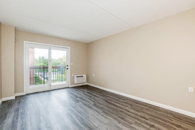 4975 Washington St Unit 313, Boston, MA 02132 - empty room with dark wood-type flooring, baseboards, and an AC wall unit