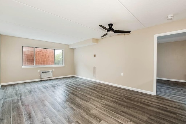4975 Washington St Unit 313, Boston, MA 02132 - empty room featuring an AC wall unit, ceiling fan, dark wood-style flooring, baseboards, and a smoke detector
