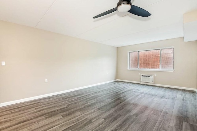 4975 Washington St Unit 313, Boston, MA 02132 - empty room with a wall mounted air conditioner, ceiling fan, dark wood-type flooring, and baseboards