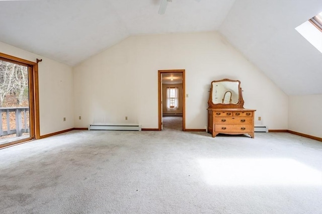 bonus room with carpet, a baseboard radiator, ceiling fan, vaulted ceiling with skylight, and baseboard heating