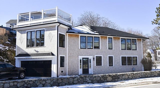 view of front facade with a garage and a balcony