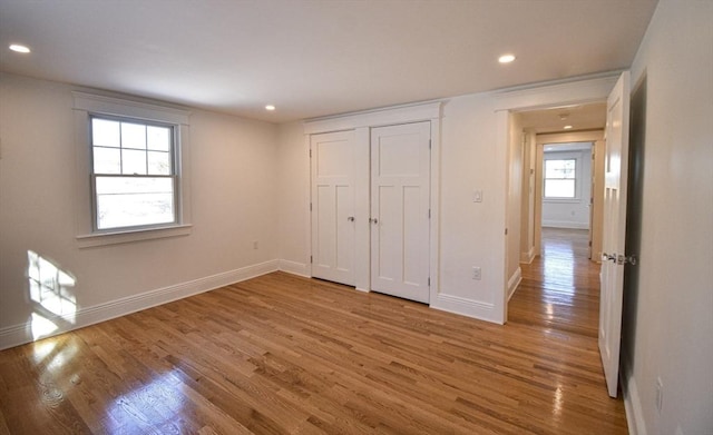 unfurnished bedroom with hardwood / wood-style flooring and a closet