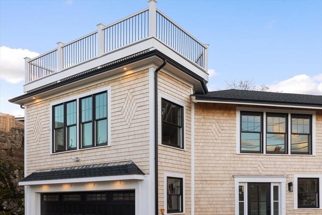 view of side of property with a balcony and a garage