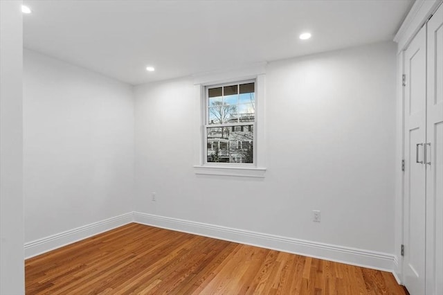 spare room featuring wood-type flooring