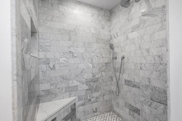 bathroom with a tile shower