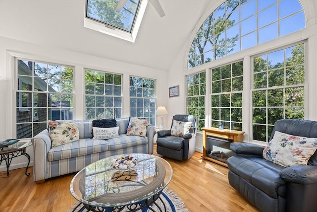 54 Mcnamara Ave, Yarmouth, MA 02673 - sunroom with high vaulted ceiling, a deck, wood finished floors, and a skylight