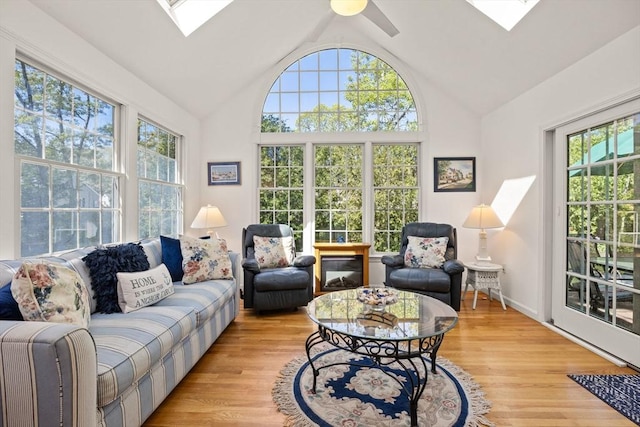 54 Mcnamara Ave, Yarmouth, MA 02673 - living area featuring a skylight, vaulted ceiling, light wood-style flooring, and ceiling fan