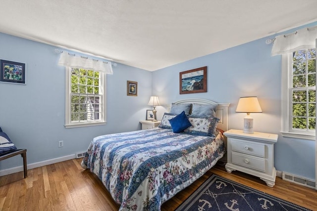 54 Mcnamara Ave, Yarmouth, MA 02673 - bedroom with multiple windows, wood finished floors, and baseboards