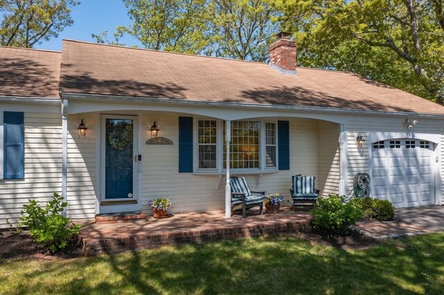 54 Mcnamara Ave, Yarmouth, MA 02673 - entrance to property with an attached garage, a chimney, and roof with shingles