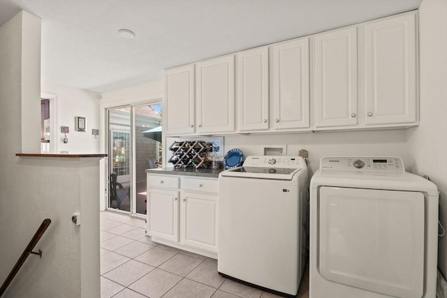 54 Mcnamara Ave, Yarmouth, MA 02673 - washroom with washer and dryer, cabinet space, and light tile patterned floors