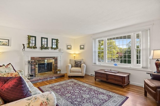 54 Mcnamara Ave, Yarmouth, MA 02673 - living room featuring wood finished floors, a fireplace, and baseboards